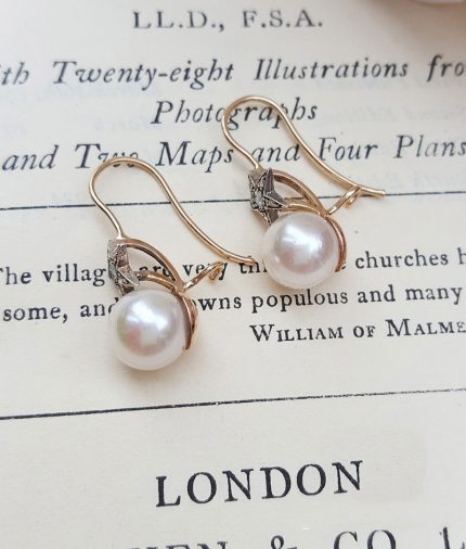 Victorian pearl earrings with a diamond adorned star