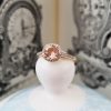 Morganite and diamond halo ring in a 9ct yellow gold setting