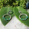 18ct white gold emerald and diamond dangly earrings
